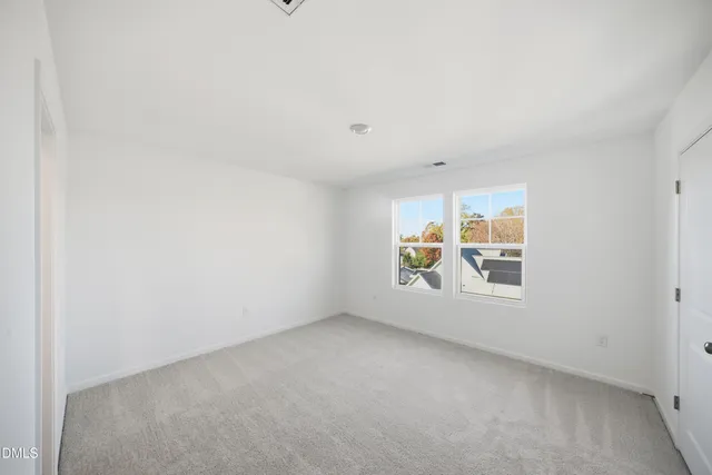 a kitchen with stainless steel appliances granite countertop a table chairs and a refrigerator