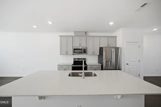 a kitchen with stainless steel appliances a stove a microwave and a refrigerator