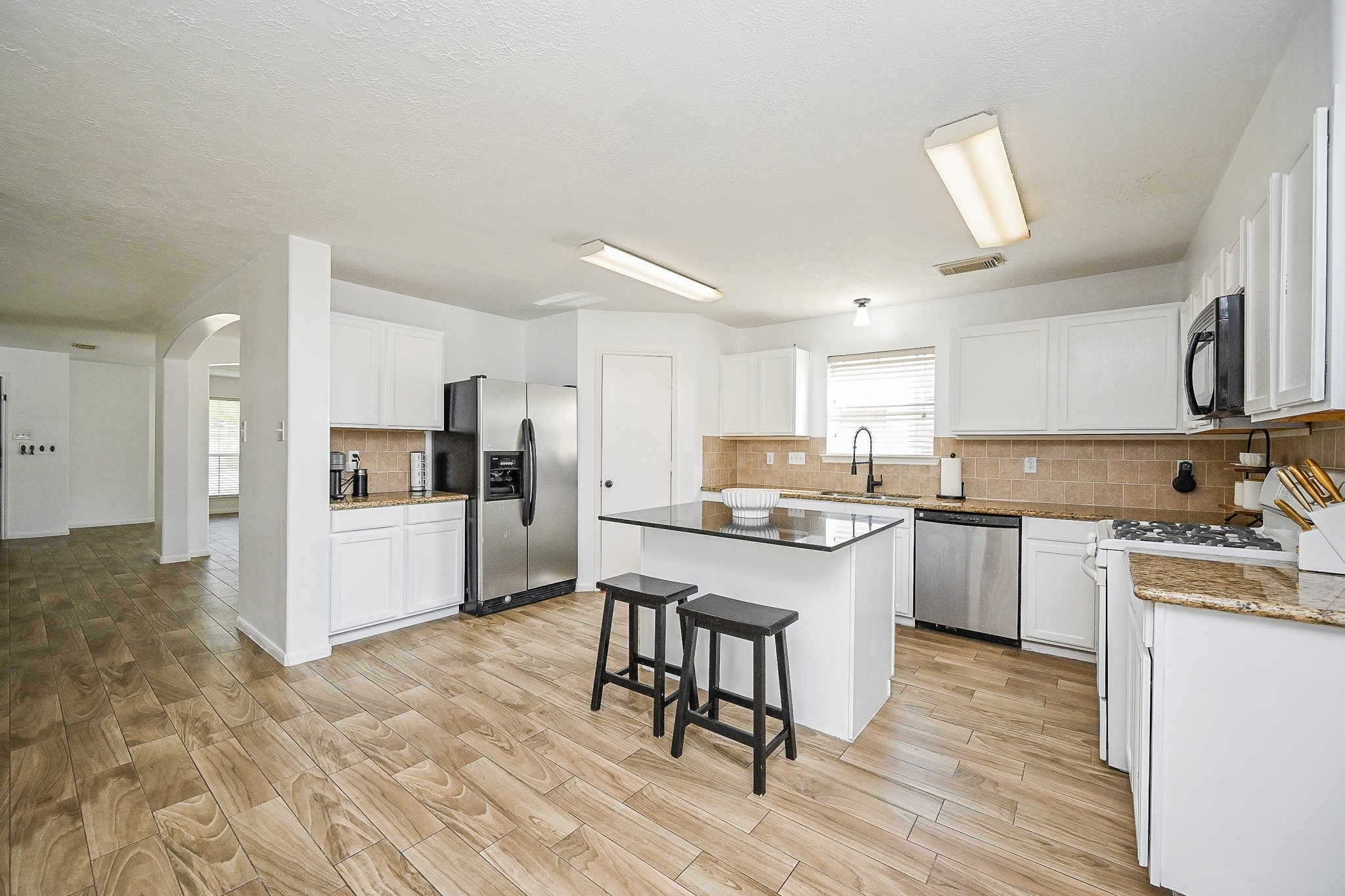 2534 Halstead Drive Spring, TX 77386 - Photo 14 of 35 a kitchen with a sink cabinets and wooden floor