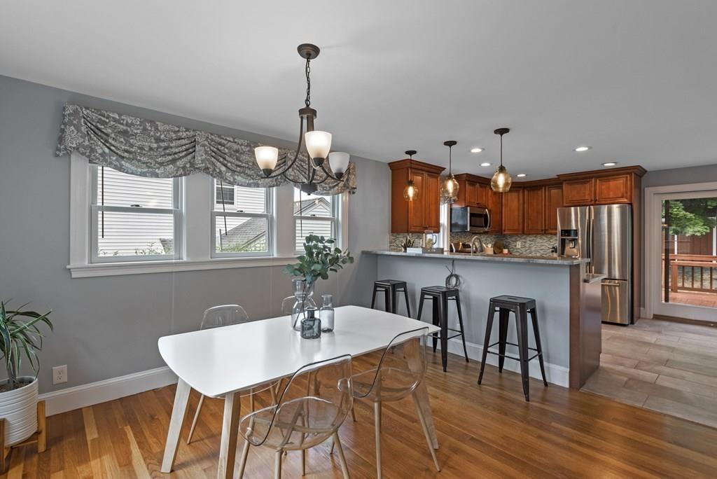 17 Lodge Road Newton, MA 02465 - Photo 5 of 31 a view of a dining room and livingroom with furniture wooden floor a chandelier