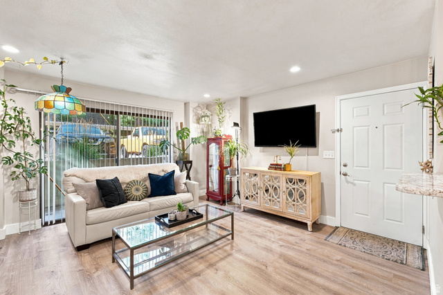 985 Springcrest Court, Unit 11 Midvale, UT 84047 - Photo 5 of 27 Wood-finish flooring, recessed lighting, and sliding glass doors with vertical blinds