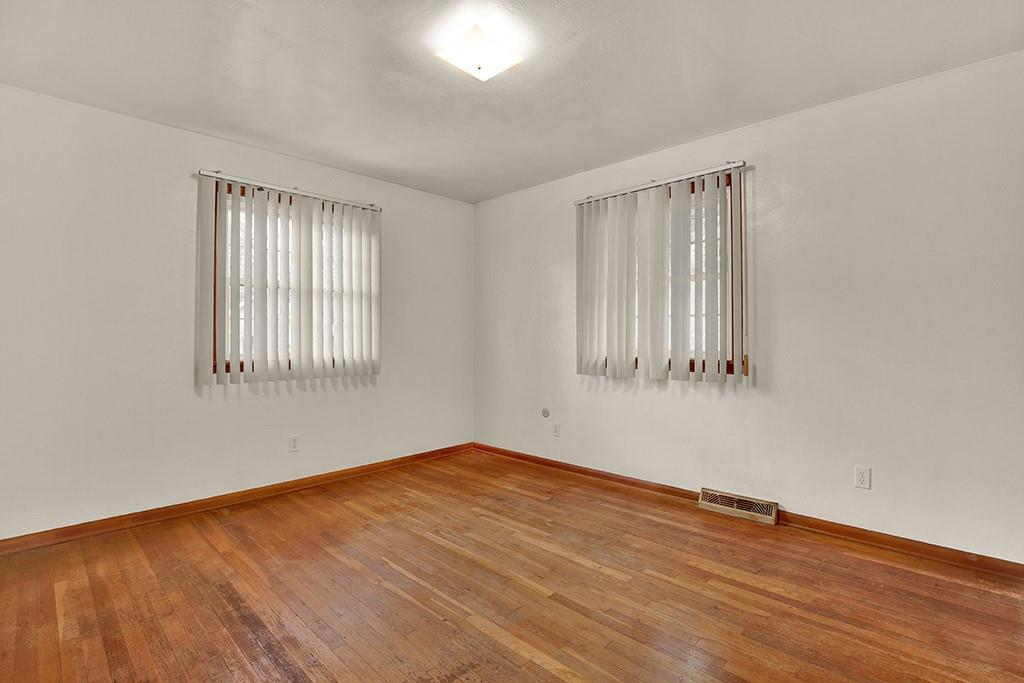 503 Virginia Drive Rostraver Township, PA 15012 - Photo 13 of 37 wooden floor in an empty room with a window