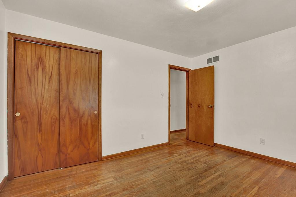 503 Virginia Drive Rostraver Township, PA 15012 - Photo 17 of 37 a view of an empty room with wooden floor and a window