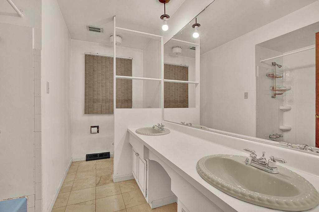 503 Virginia Drive Rostraver Township, PA 15012 - Photo 10 of 37 a bathroom with a sink and a mirror