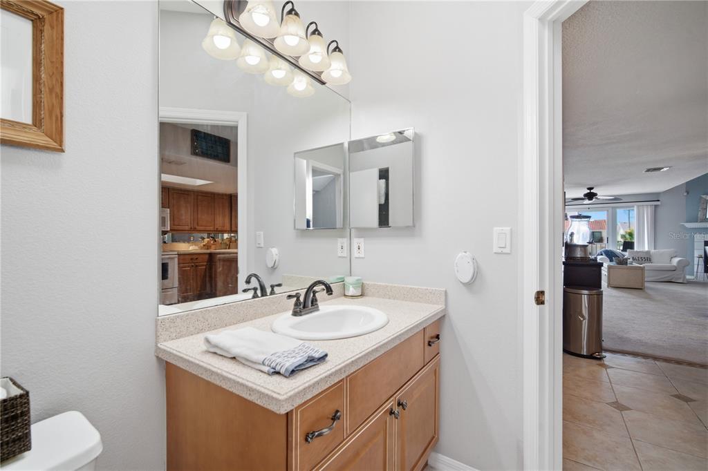 643 Garland Circle Indian Rocks Beach, FL 33785 - Photo 29 of 81 a bathroom with a sink vanity and a mirror