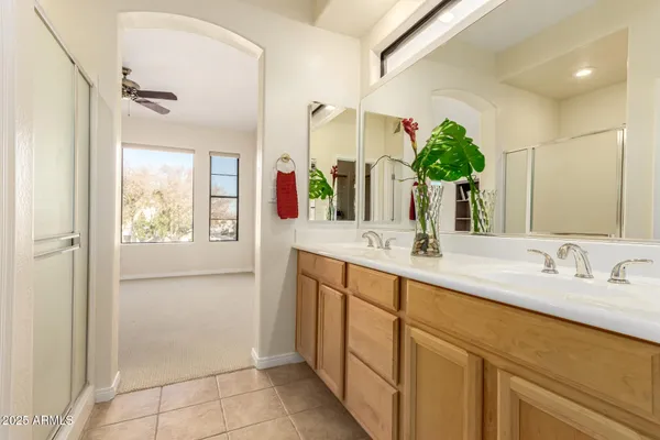 a bathroom with a double vanity sink and a mirror