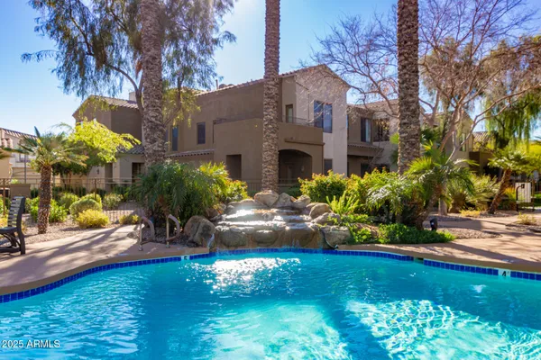 a front view of a house with a yard and a garden