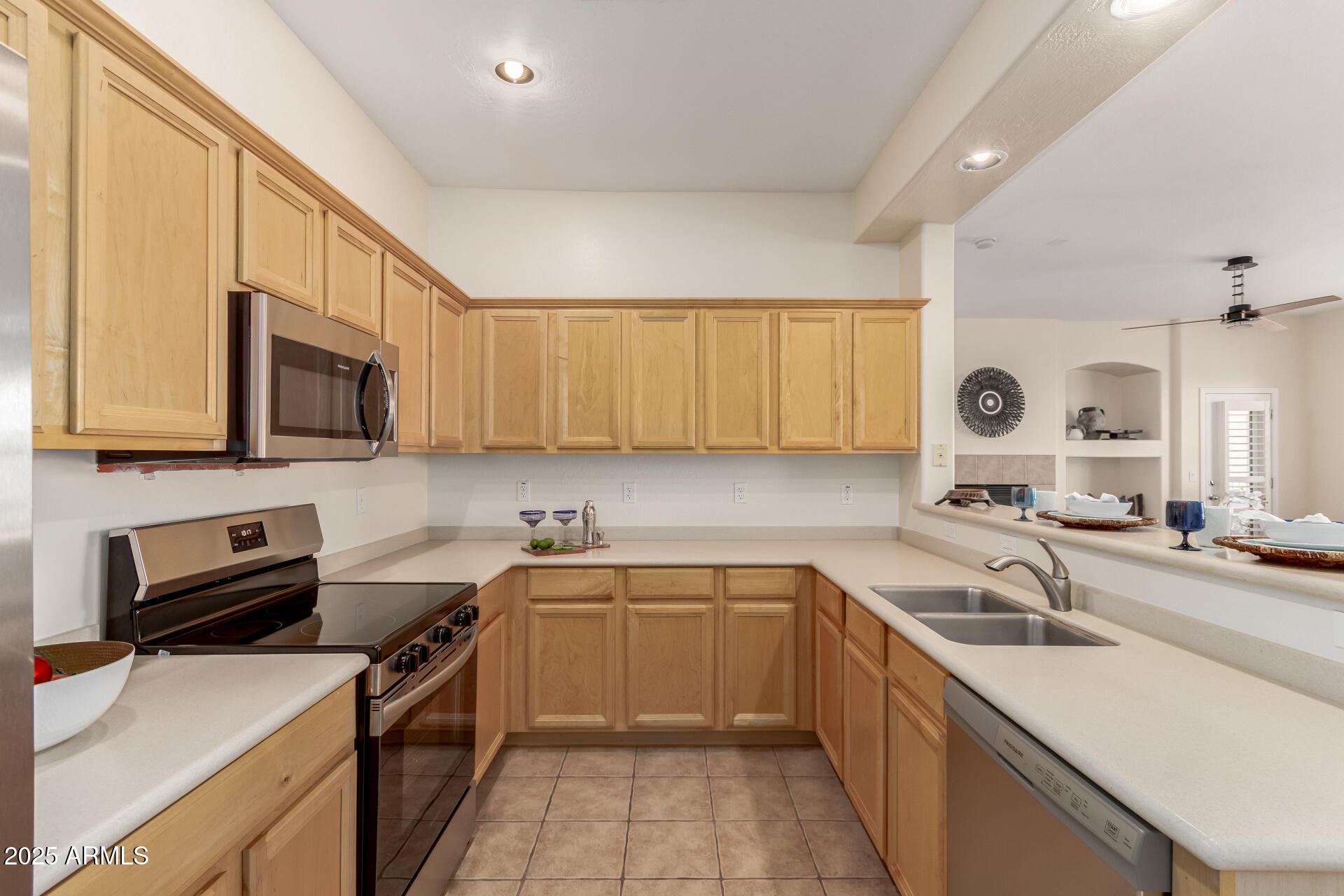 3131 East Legacy Drive, Unit 2041 Phoenix, AZ 85042 - Photo 8 of 49 a kitchen with a sink a stove top oven and cabinetry