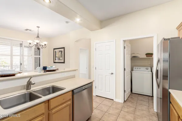 a kitchen with a sink a stove top oven and cabinetry