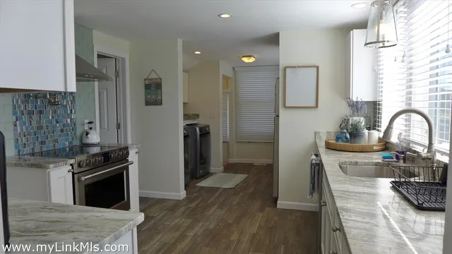 a kitchen with a refrigerator stove and sink