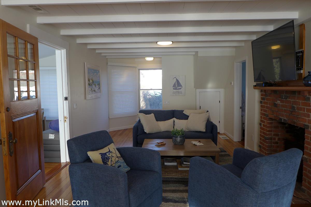 34 Windemere Road Oak Bluffs, MA 02557 - Photo 14 of 44 a living room with furniture and a fireplace