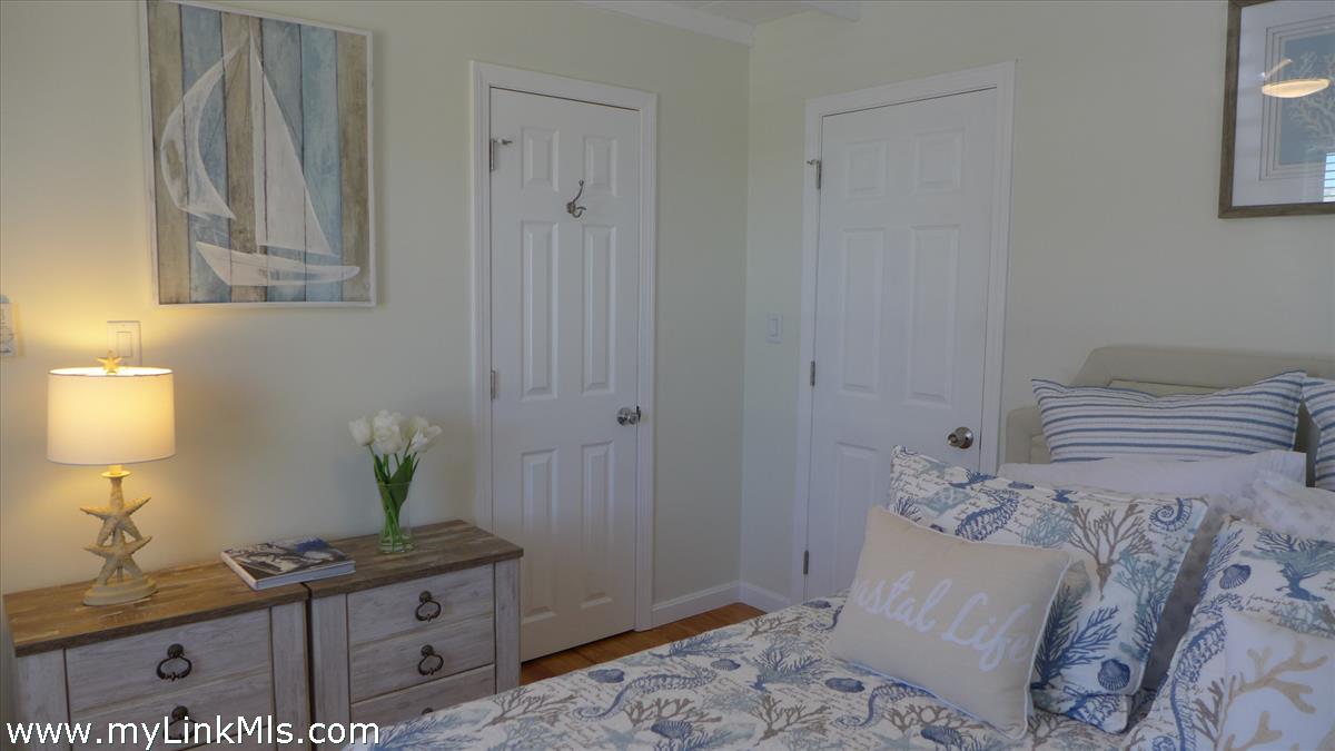 34 Windemere Road Oak Bluffs, MA 02557 - Photo 18 of 44 a bedroom with a bed and a potted plant on the dresser