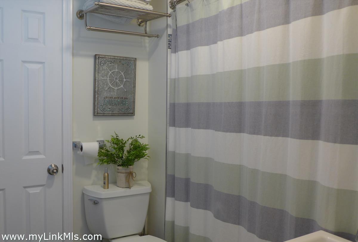 34 Windemere Road Oak Bluffs, MA 02557 - Photo 20 of 44 a bathroom with a shower curtain and a toilet
