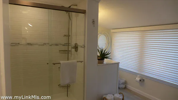 a bathroom with a shower and a sink
