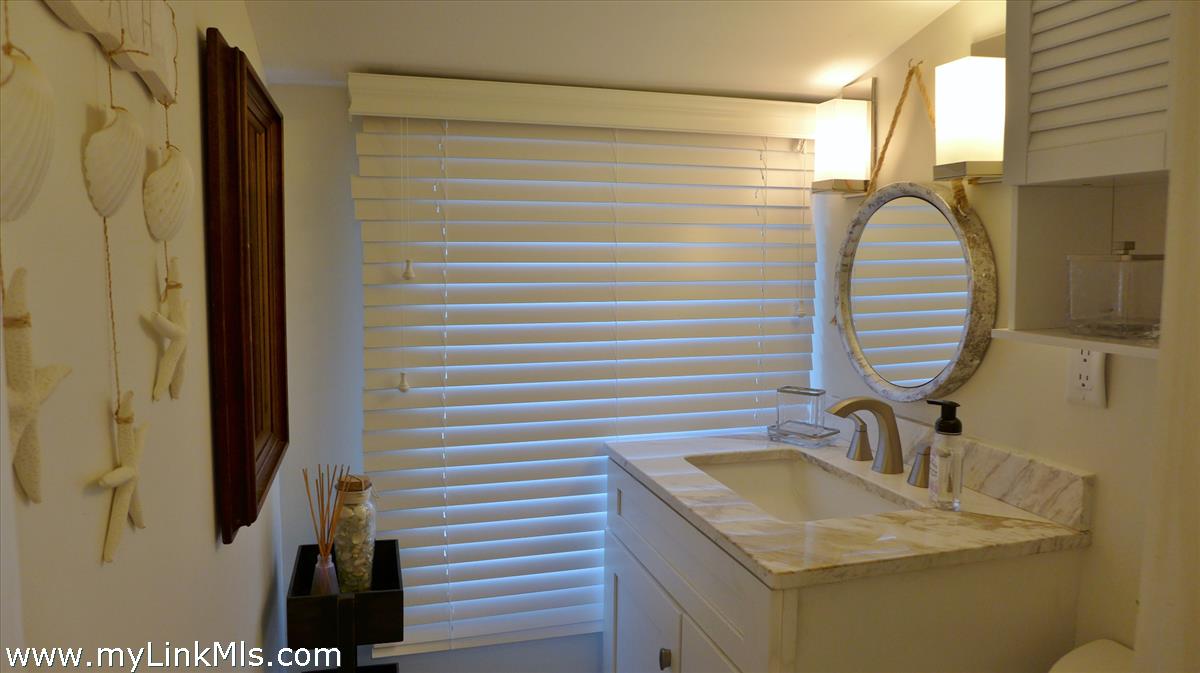 34 Windemere Road Oak Bluffs, MA 02557 - Photo 30 of 44 a bathroom with a sink and mirror
