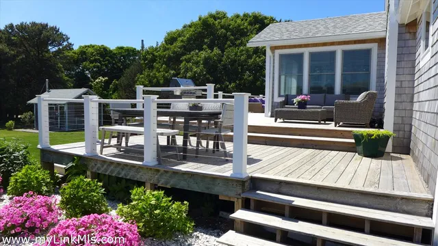 a view of a deck with table and chairs and potted plants