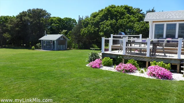 a front view of a house with swing and flower plants