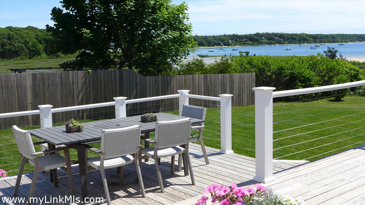 34 Windemere Road Oak Bluffs, MA 02557 - Photo 35 of 44 a view of a patio with a table chairs and a small yard