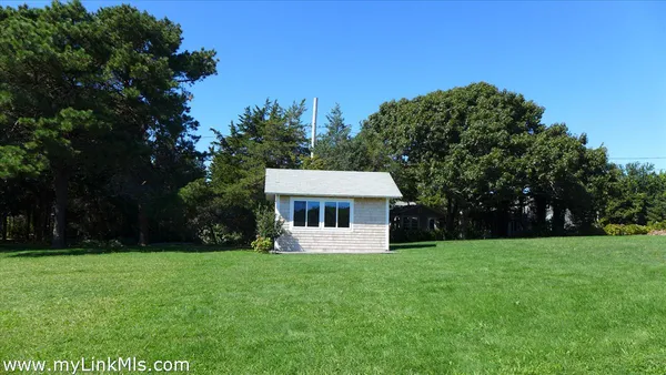 a front view of house with a garden