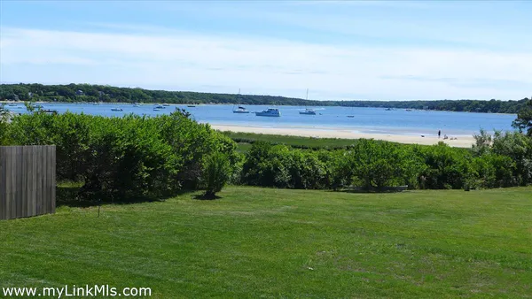 a view of a field with an ocean