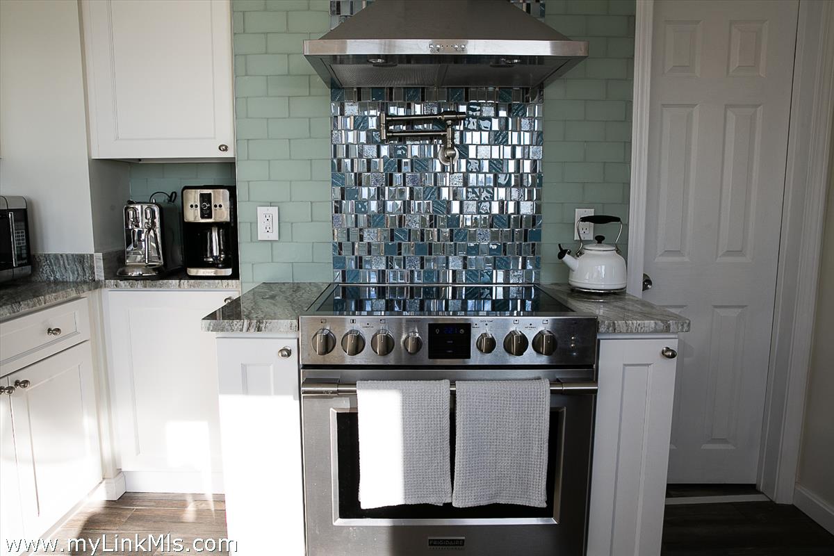 34 Windemere Road Oak Bluffs, MA 02557 - Photo 8 of 44 a kitchen with a sink and cabinets