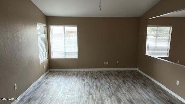 2702 South Ananea Mesa, AZ 85209 - Photo 13 of 15 an empty room with wooden floor and windows