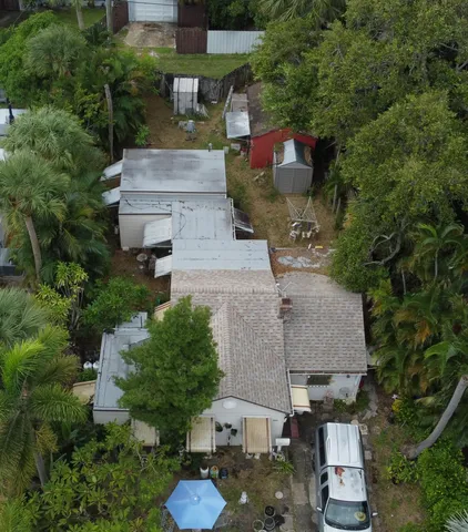 an aerial view of a house with a yard basket ball court and outdoor seating