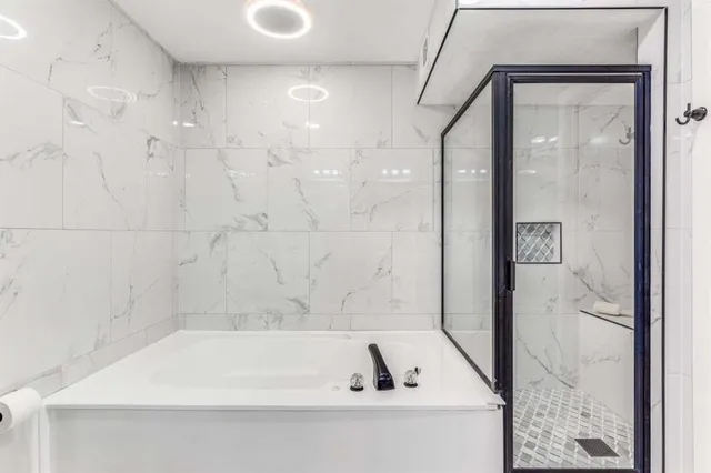 a bathroom with a bathtub and a shower
