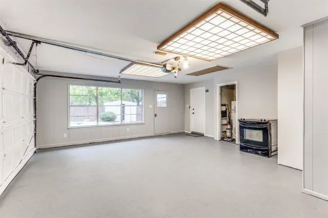 an empty room with windows lake and mountain view