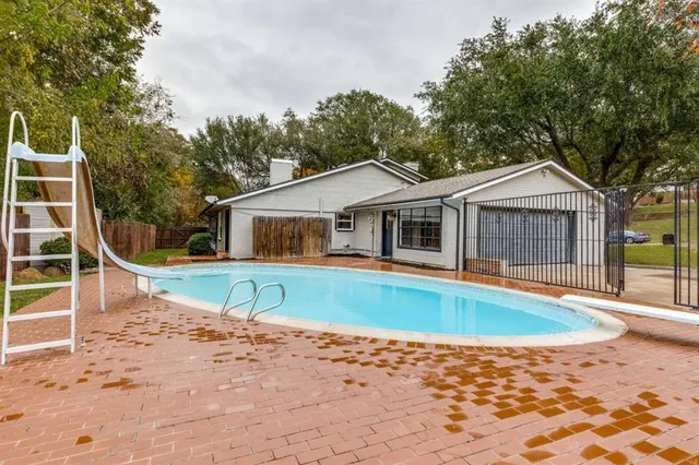 a front view of a house with a swimming pool