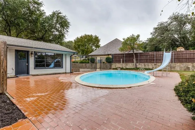 a view of a swimming pool with a patio