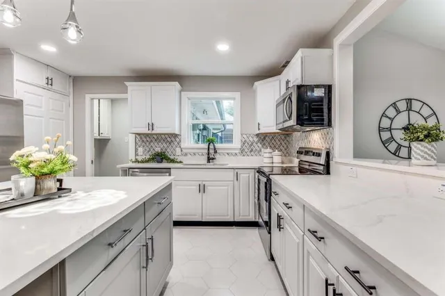 a kitchen with a sink white cabinets and white appliances