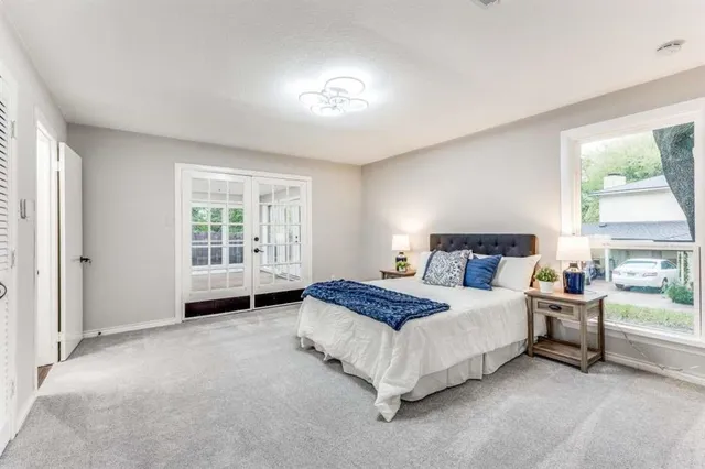 a spacious bedroom with a bed and a window