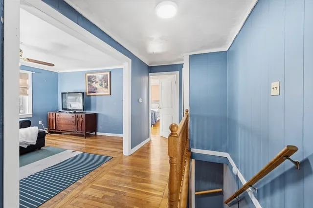 a bedroom with furniture and a wooden floor
