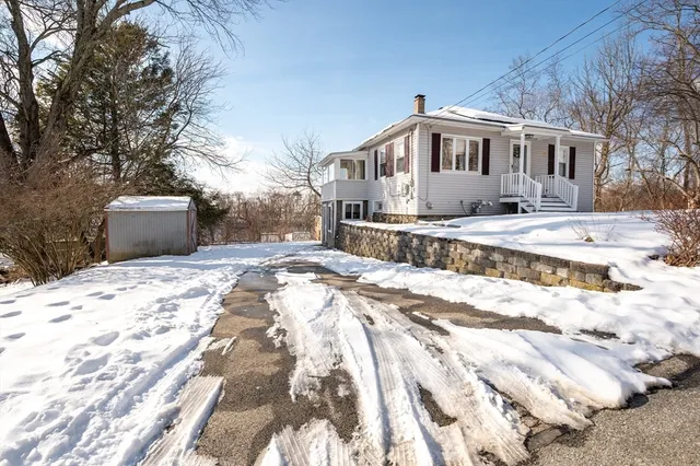 a view of a house with snow on the background