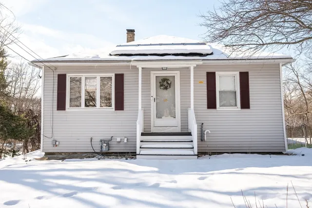 a view of a house with a garden and garage