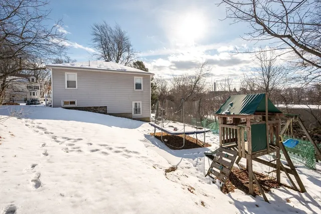 a wooden bench sitting in middle of a yard