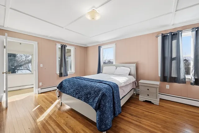 a spacious bedroom with a bed and a large window