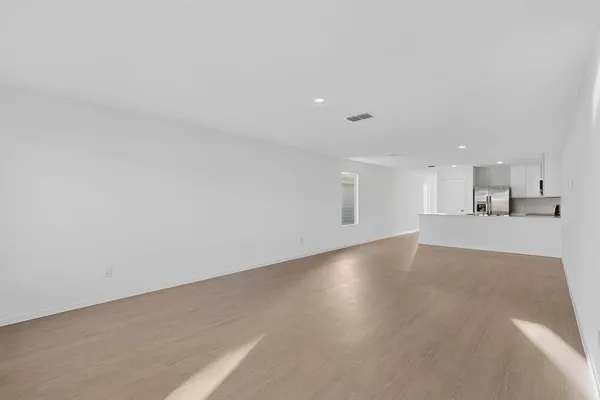 a view of a kitchen with kitchen island and wooden floor