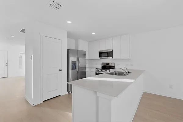 a kitchen with a sink stove and microwave