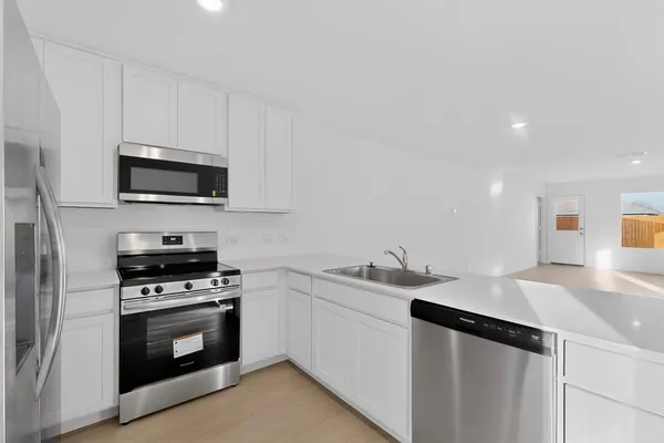 a kitchen with a refrigerator and cabinets