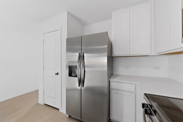 a kitchen with a sink cabinets and a window