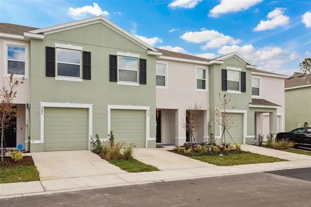 a front view of a house with yard and garage