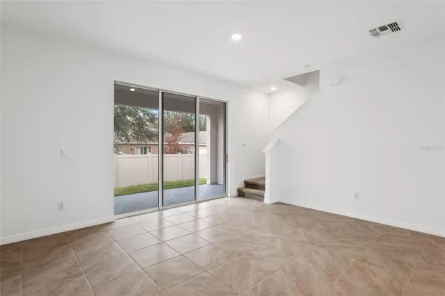 a view of an empty room with glass door