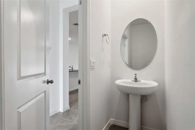 a bathroom with a sink a mirror and shower