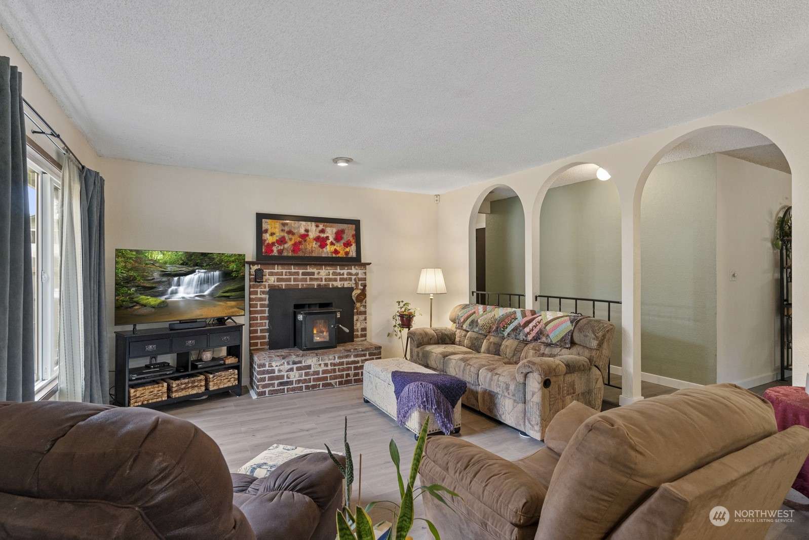 2103 Timber Trail Bothell, WA 98012 - Photo 17 of 40 a living room with furniture a fireplace and a large window