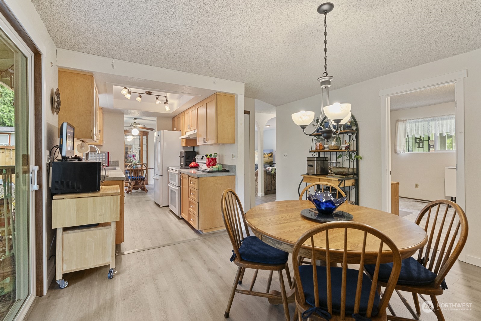 2103 Timber Trail Bothell, WA 98012 - Photo 23 of 40 a view of a dining room and livingroom with furniture wooden floor a chandelier
