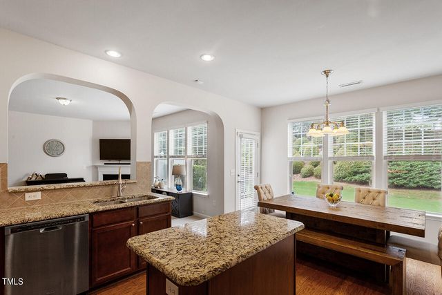 a kitchen with a granite countertop sink and a stove