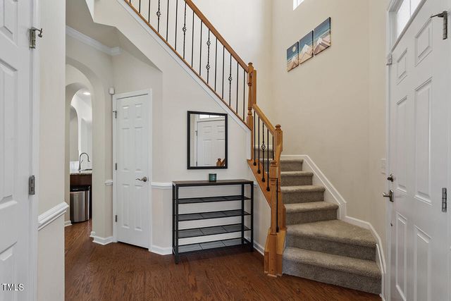a view of entryway and hall with wooden floor