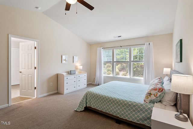 a spacious bedroom with a bed and a window